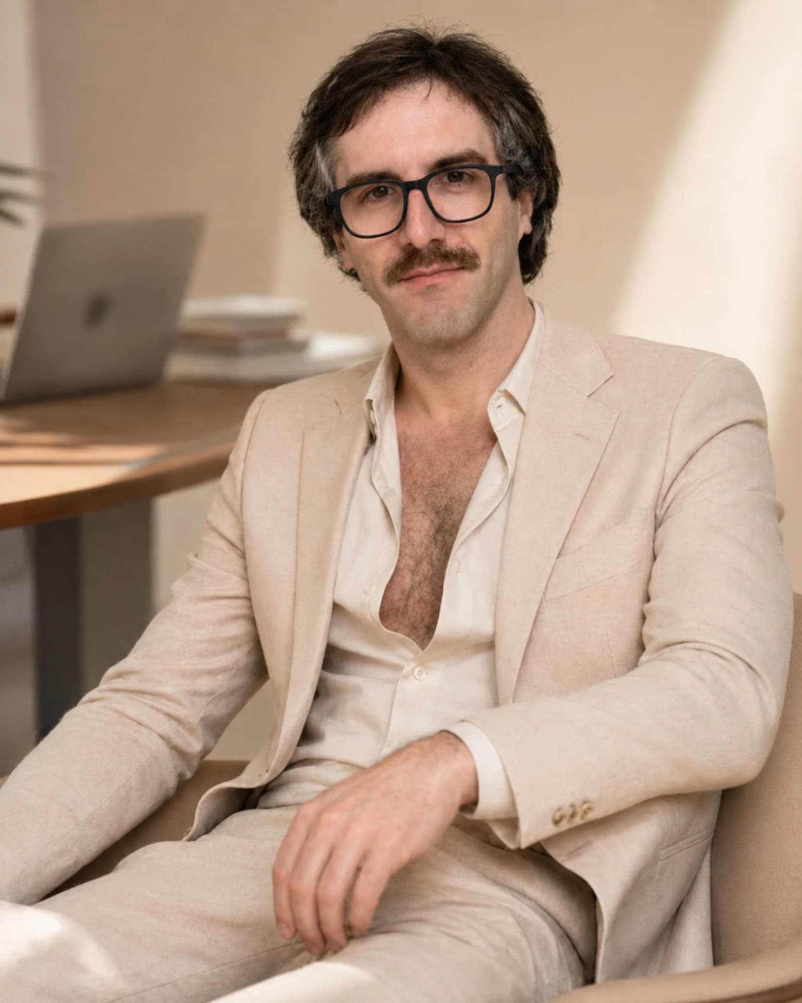 Patrick Gallagher seated in a studio workspace